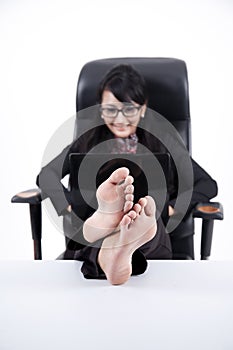 Business Woman with Feet Up on a Table