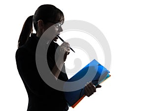 Business woman focused holding folders files silhouette