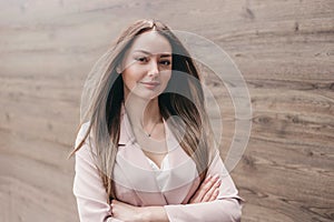 business woman with folded hands on the background of an office building