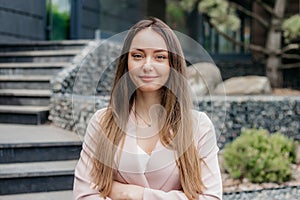 business woman with folded hands on the background of an office building