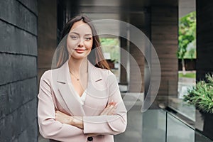 Business woman with folded hands on the background of an office building