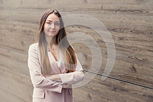 business woman with folded hands on the background of an office building