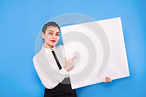 Business woman in formal wear with white panel on blue background