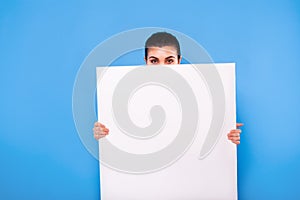 Business woman in formal wear with white panel on blue background