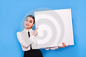 Business woman in formal wear with white panel on blue background