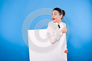 Business woman in formal wear with white panel on blue background