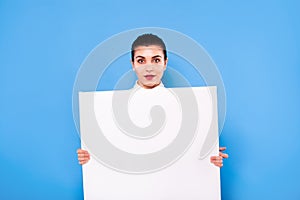 Business woman in formal wear with white panel on blue background