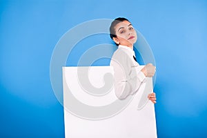 Business woman in formal wear with white panel on blue background