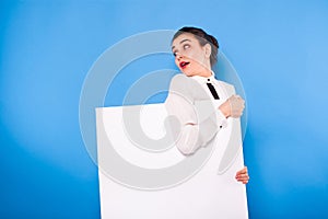 Business woman in formal wear with white panel on blue background