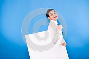 Business woman in formal wear with white panel on blue background