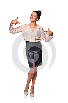 Business woman in full length pointing at herself