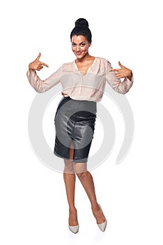 Business woman in full length pointing at herself