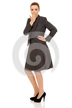 Business woman giggles covering her mouth with hand