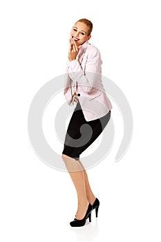 Business woman giggles covering her mouth with hand
