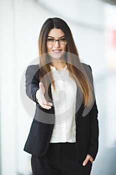 Business woman giving a hand. handshake in the office