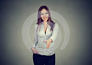 Business woman giving a handshake isolated on gray background