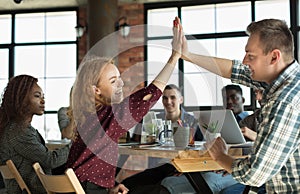 Business woman giving high five and smiling to man