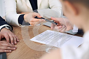 Business woman giving pen to businessman ready to sign contract. Success communication at meeting or negotiation