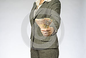 Business woman with gray jacket parses the money fan. 