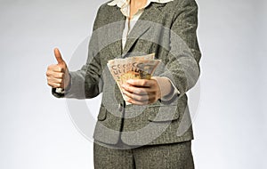 Business woman with gray jacket parses the money fan.