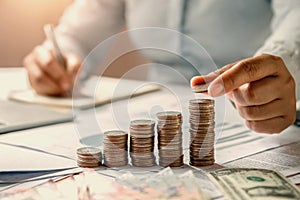 business woman hand holding coins to stack on desk concept saving money finance