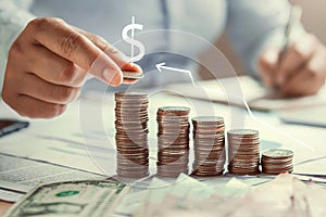 business woman hand holding coins to stack on desk concept saving money finance