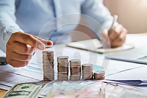 business woman hand holding coins to stack on desk concept saving money finance