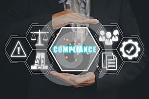 Business woman hand holding compliance icon on virtual screen