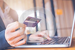 Business woman hand holds a blue credit card