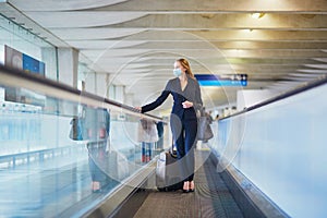 Business woman with hand luggage in international airport