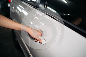 Business woman hand open person white car. Automobile vehicle female owner catching a door handle. Driver, service, lock,