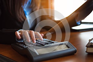 Business woman hand pressing on calculator for calculating cost estimating