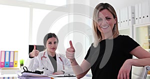 Business woman hand showing OK sign with thumb up at doctor appointment