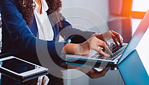 business woman hand typing on laptop computer keyboard with reflection on digital tablet on office table, online working