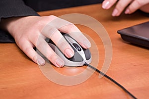 Business woman hand working on a computer mouse at