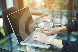 Business woman hand working laptop computer in office