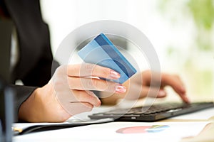Business woman hands with credit card and keyboard
