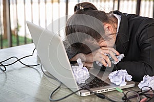 Business woman hands crumple sheets at the desk, mistake contract - failure business concept photo