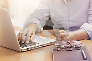 Business woman hands holding credit card.