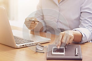 Business woman hands holding credit card.