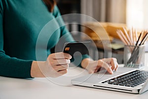 Business woman hands holding credit card with digital layer effect diagram as Online shopping concept