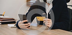 Business woman hands holding credit card with digital layer effect diagram as Online shopping concept