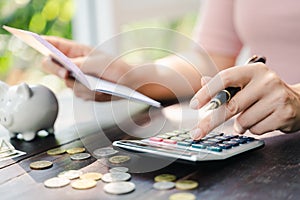 Business woman hands holding saving account passbook with calculator, account and saving concept