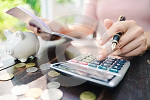 Business woman hands holding saving account passbook with calculator, account and saving concept