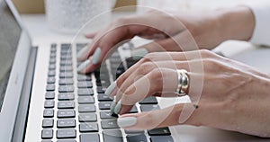 Business woman, hands and laptop typing email, research or communication on office desk. Hand of female employee working
