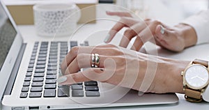 Business woman, hands and laptop typing for research, email or communication on office desk. Hand of female employee