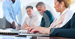 Business woman hands typing email on laptop in a team planning or strategy meeting in a corporate work office. Teamwork