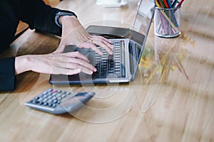 Business woman hands typing on the notebook keyboard at the table in office. Business technology concept