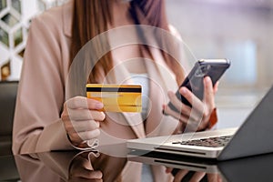 Business woman hands using smartphone and holding credit card as Online shopping