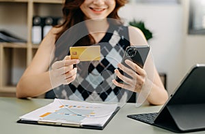 Business woman hands using smartphone and holding credit card as Online shopping
